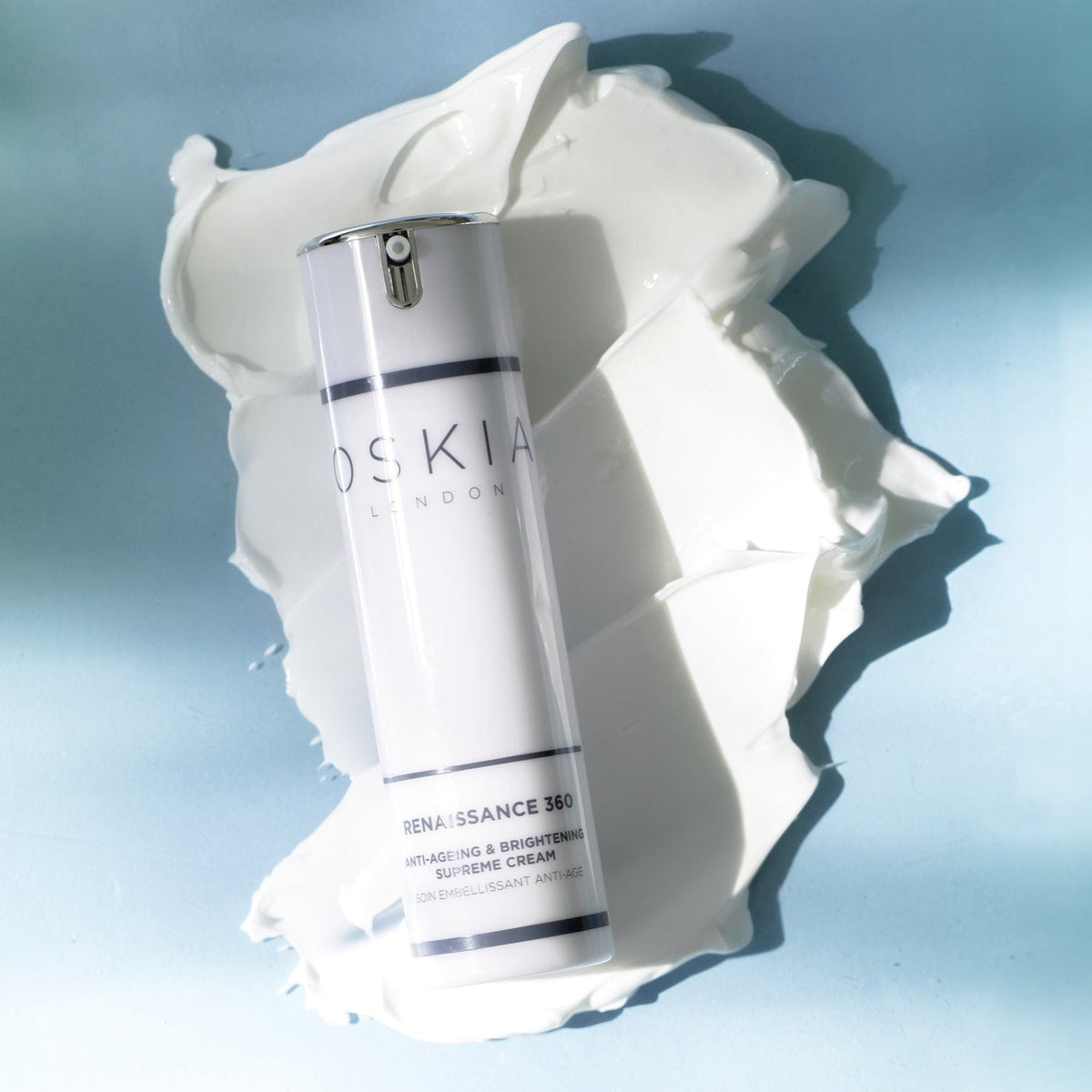 Oskia Renaissance 360 bottle on a swatch of cream