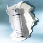 Oskia Renaissance 360 bottle on a swatch of cream