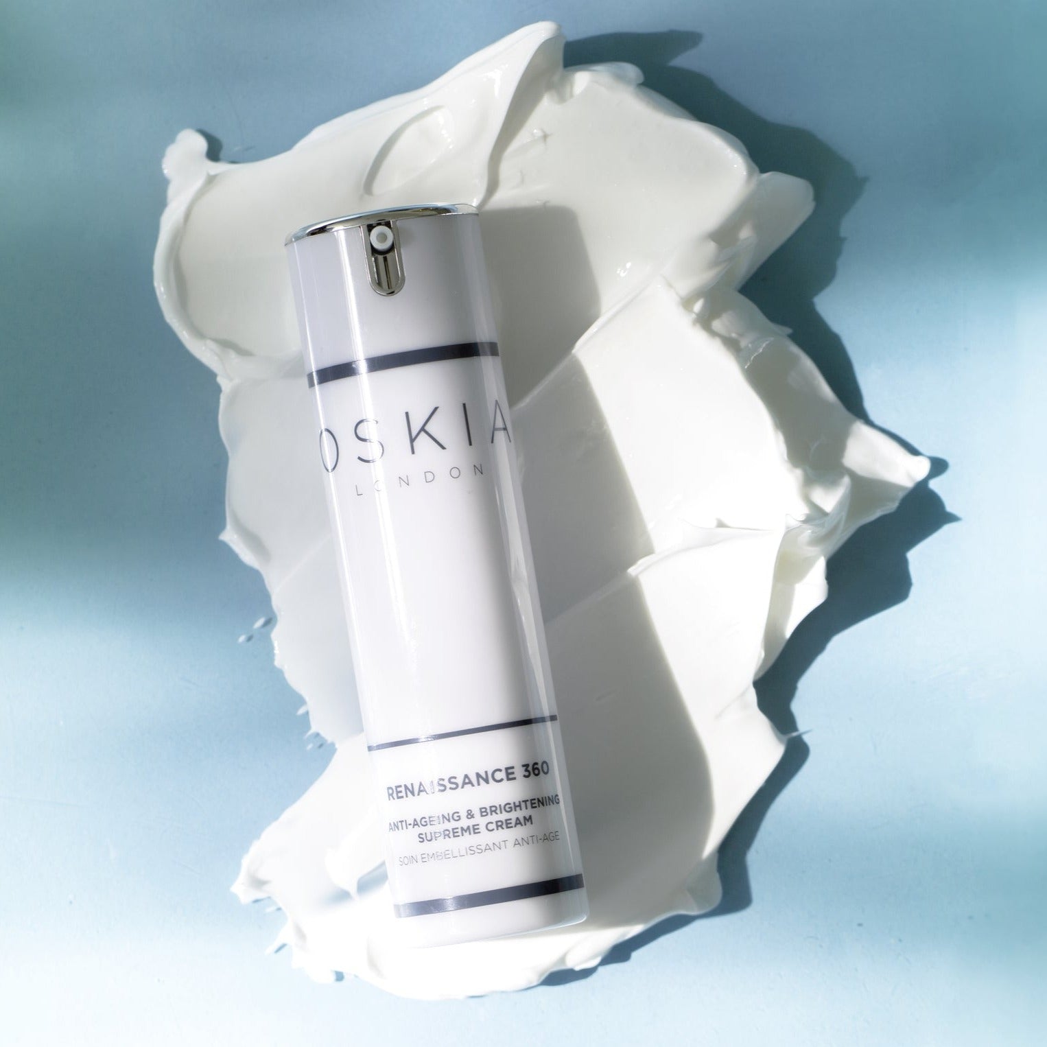 Oskia Renaissance 360 bottle on a swatch of cream