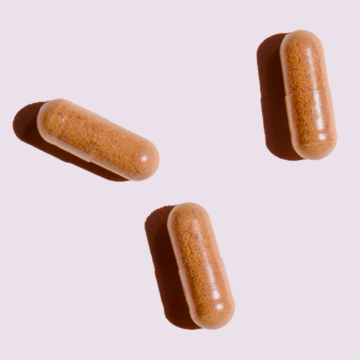 Atelier Nubio A Natural, Rosy Glow, S'il Vous Plait capsules on a pale pink background