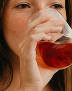 Atelier Nubio Ballerina Legs, S'il Vous Plait model drinking the diluted ampoule from a glass