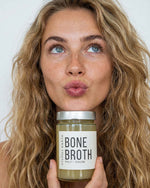 Atelier Nubio Bone Broth Chicken & Turmeric jar held by a model