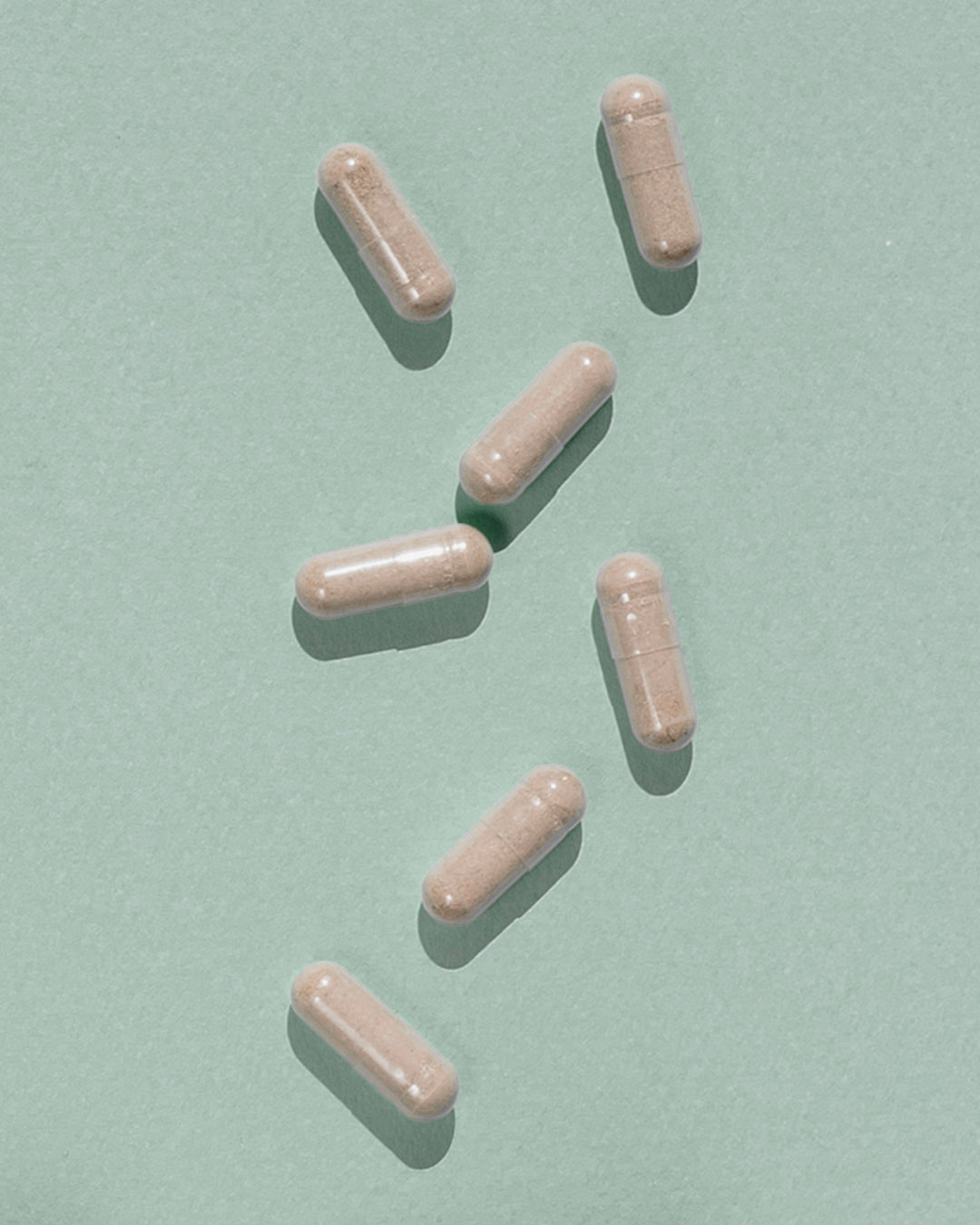 Atelier Nubio Purify My Body, S'il Vous Plait capsules on a sage green background
