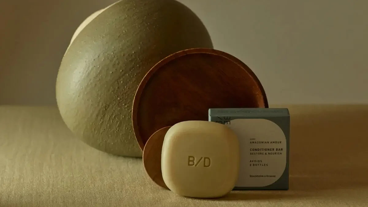 Beauty Disrupted Conditioner and Mask bar with its Amazonian Amour box beside a ceramic bowl