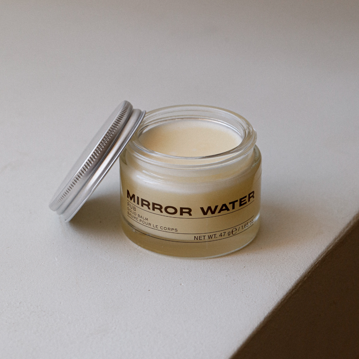 MIRROR WATER RUB Solid Balm open jar showing the solid shea balm texture