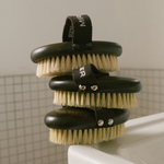 MIRROR WATER Ultra-Soft BUFF Body Dry Brush three brushes stacked bristles-up on a bathroom sink