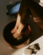 Muihood Mugwort Bath Soak used as a foot soak in a wooden bowl