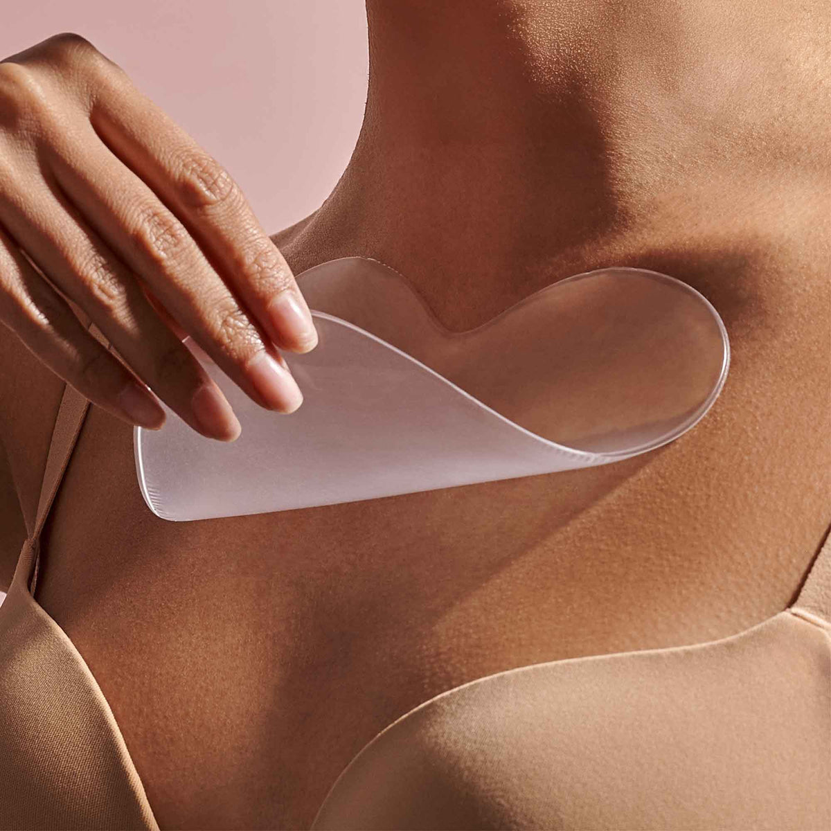 NAYDAYA Chest Wrinkle Shield silicone patch being applied to a model's chest