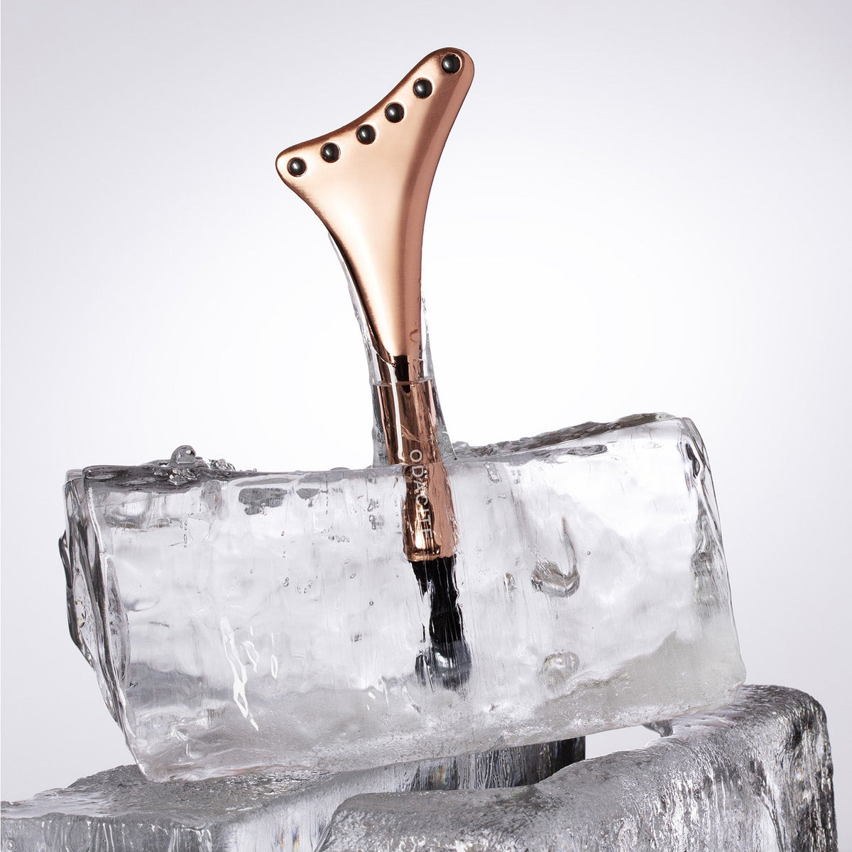 Odacité Cryo-Tech Facial Tool standing in a block of ice